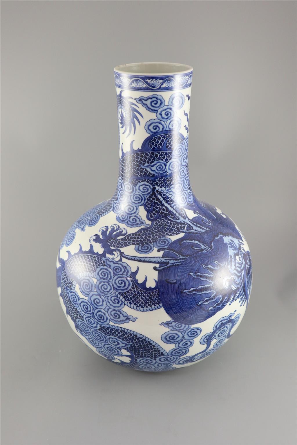 A large Chinese dragon bottle vase, Qianlong seal mark, probably late 19th century, 47cm high, wood stand